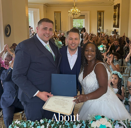 Photograph of Neil at the end of a wedding ceremony, presenting the bride and groom with their wedding certificate. The groom stands to the left of Neil, the bride stands on the right and is wearing a white wedding dress. Clicking on this photo takes you to the "about" page on the website.